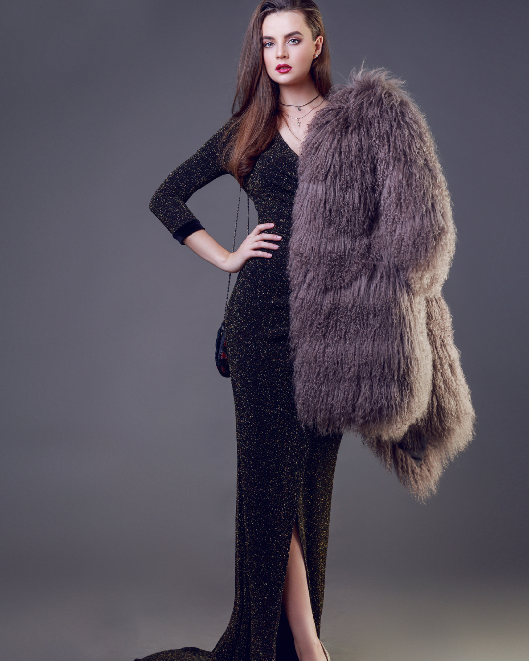 An exquisite evening gown made of shimmering black fabric, with a luxurious fur style and a sophisticated fashion appeal, designed by Riti Fashion Designer.