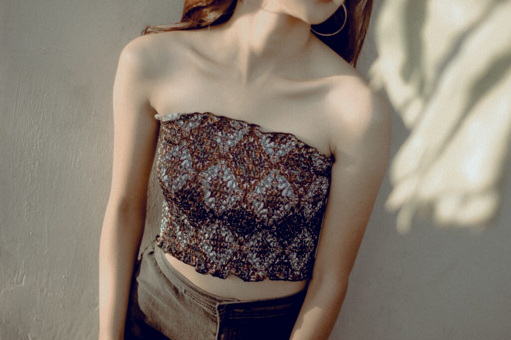 Tops Portrait of a woman in a strapless top with elegant lighting, perfect for fashion or lifestyle themes.