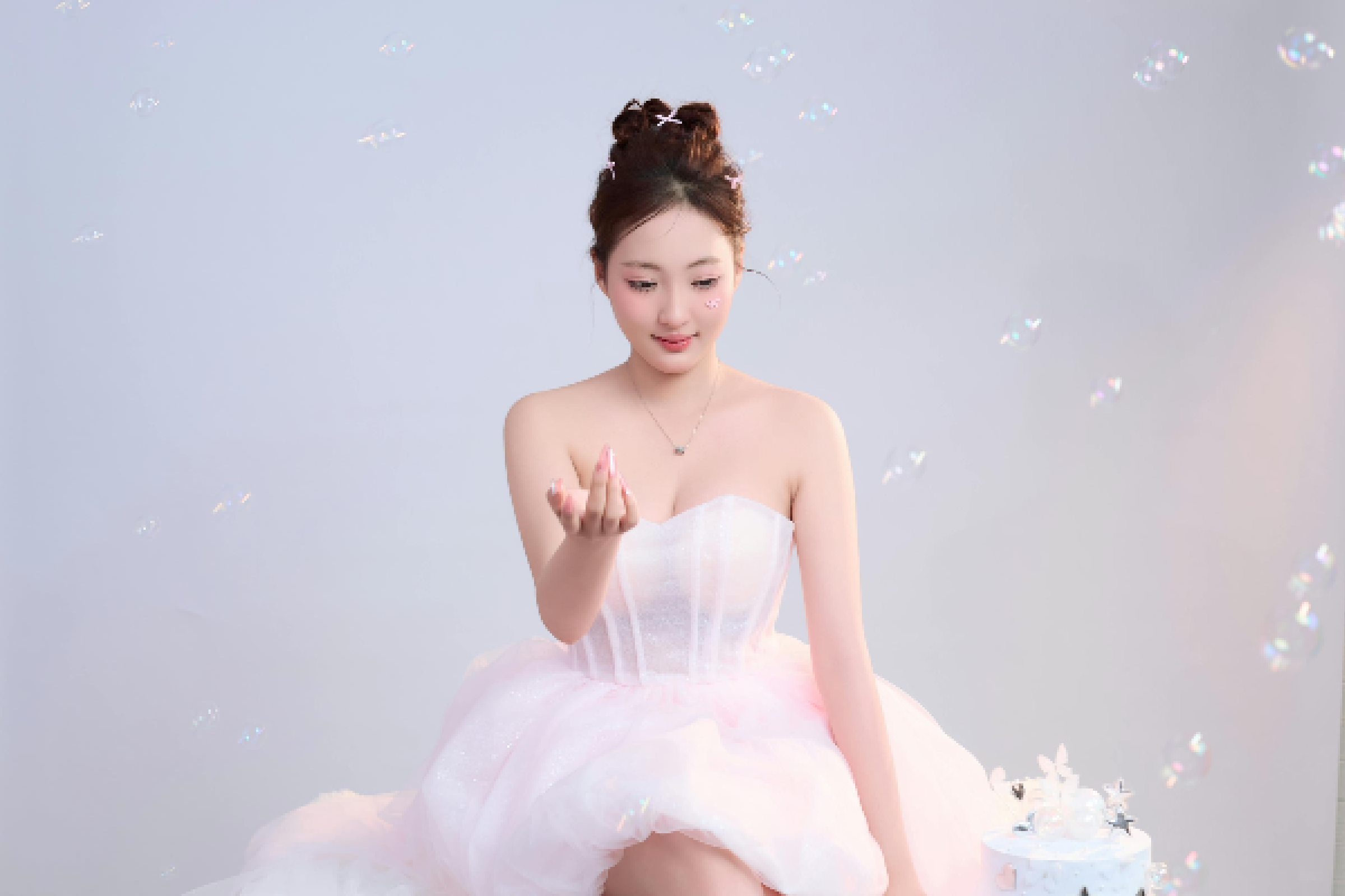Blush Dream Princess Tulle Party Dress | Elegant Strapless Mini Dress Woman wearing a blush pink strapless princess-style tulle mini dress with a sweetheart neckline and layered skirt, styled for an elegant party or special occasion.